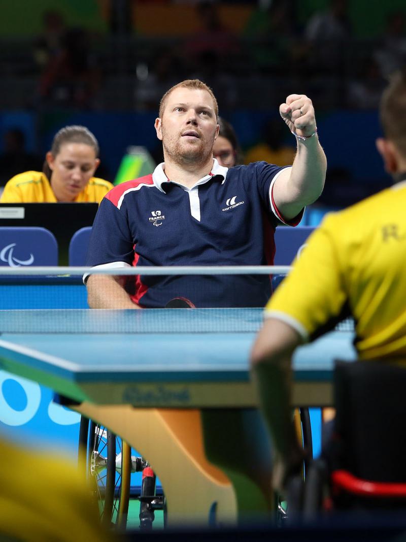 male Para table tennis player Fabien Lamirault punches the air after a shot