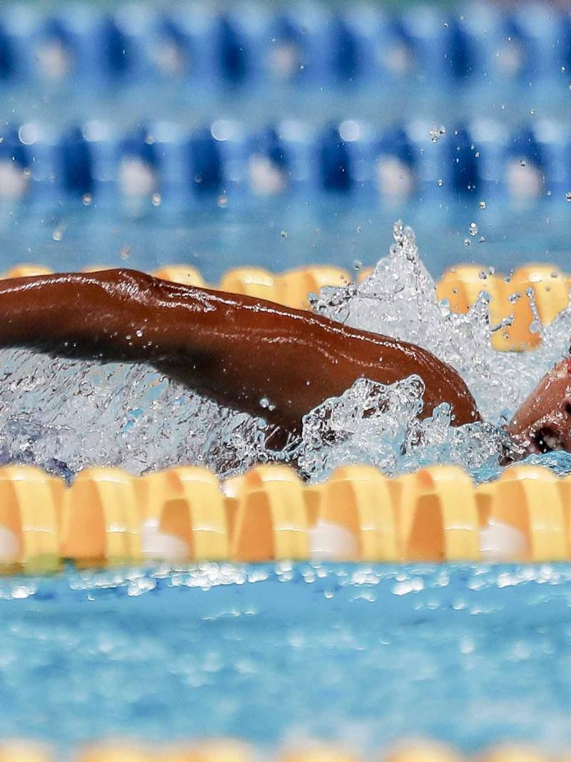 female Para swimmer Indriani Syuci in the pool completing a freestyle stroke
