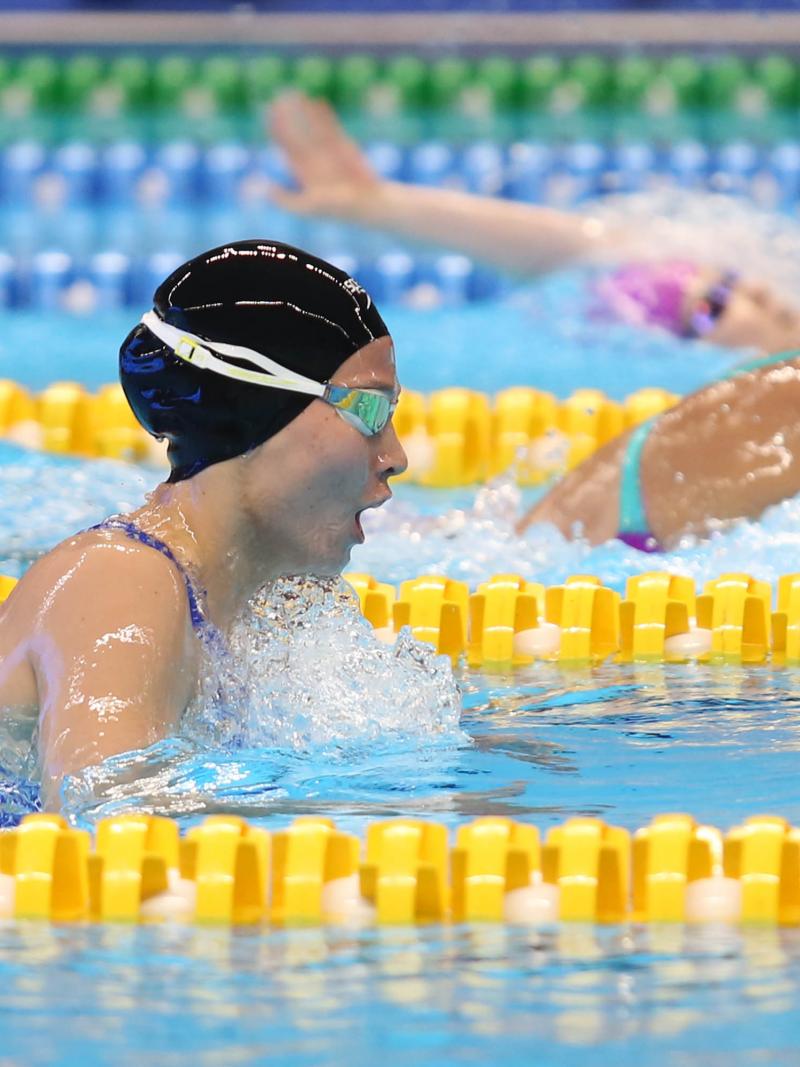 female Para swimmer Amilova Fotimakhon takes a breath during a breaststroke