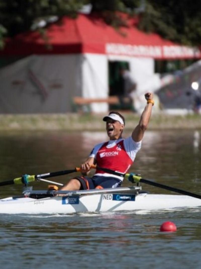 Man celebrating in a rowing boat