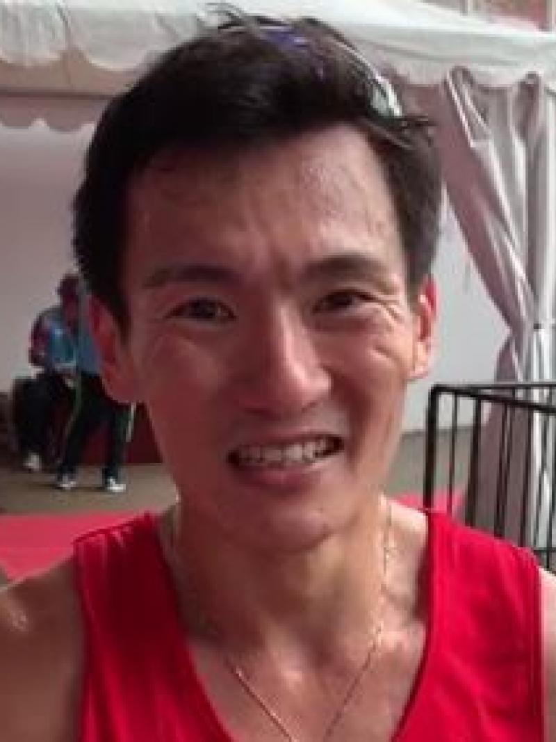 male Para athlete Zac Leow Zi Xiang smiles at the camera
