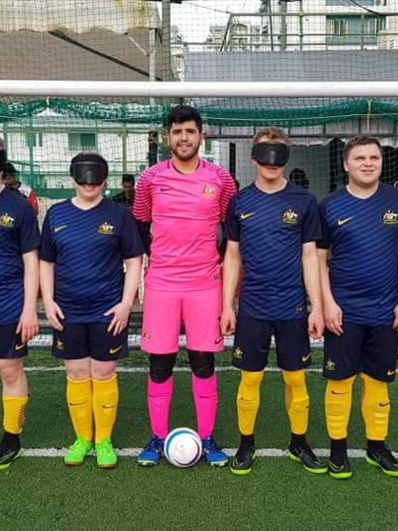 Seven man standing on an artifical turf football pitch
