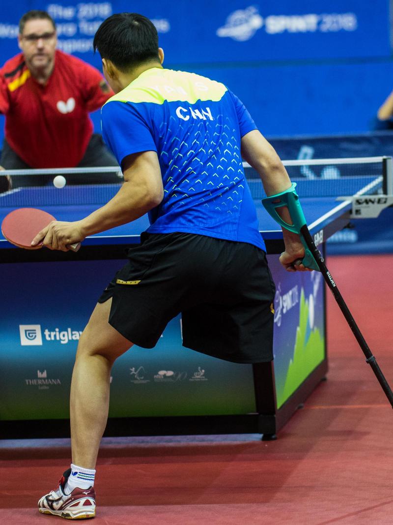 male Para table tennis player Yan Shuo plays a forehand