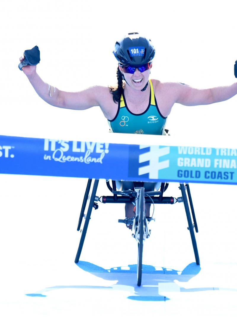 Australia woman in wheelchair raises arms before crossing finish line