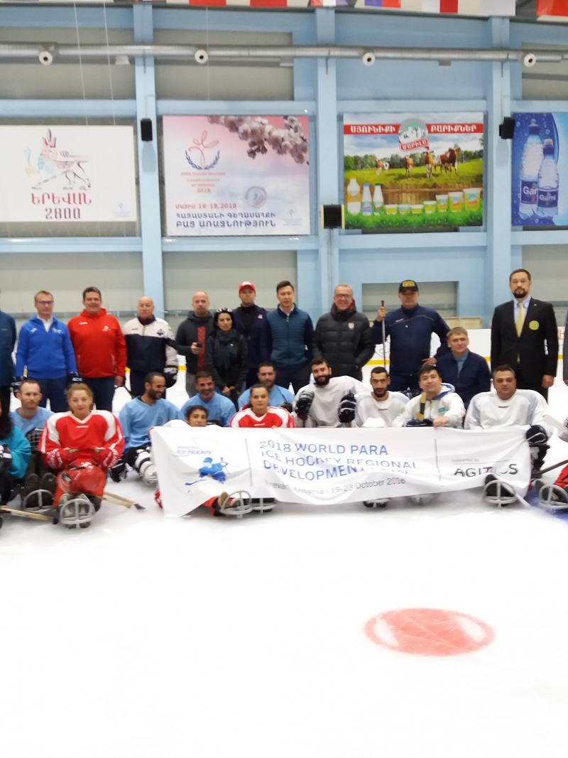 A group of people on sledges on an ice hockey rink