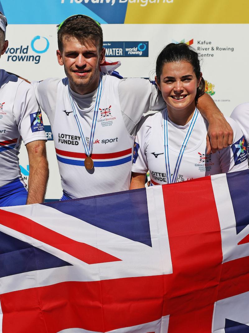 five Para rowers with Ellen Buttrick on the right holding up a Great Britain flag