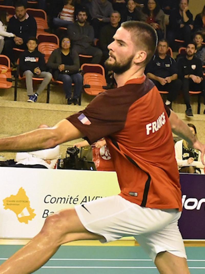 male Para badminton player Lucas Mazur plays a backhand