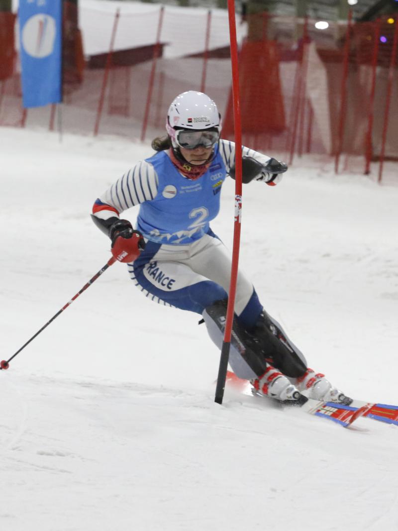 female Para alpine skier Marie Bochet goes round a gate