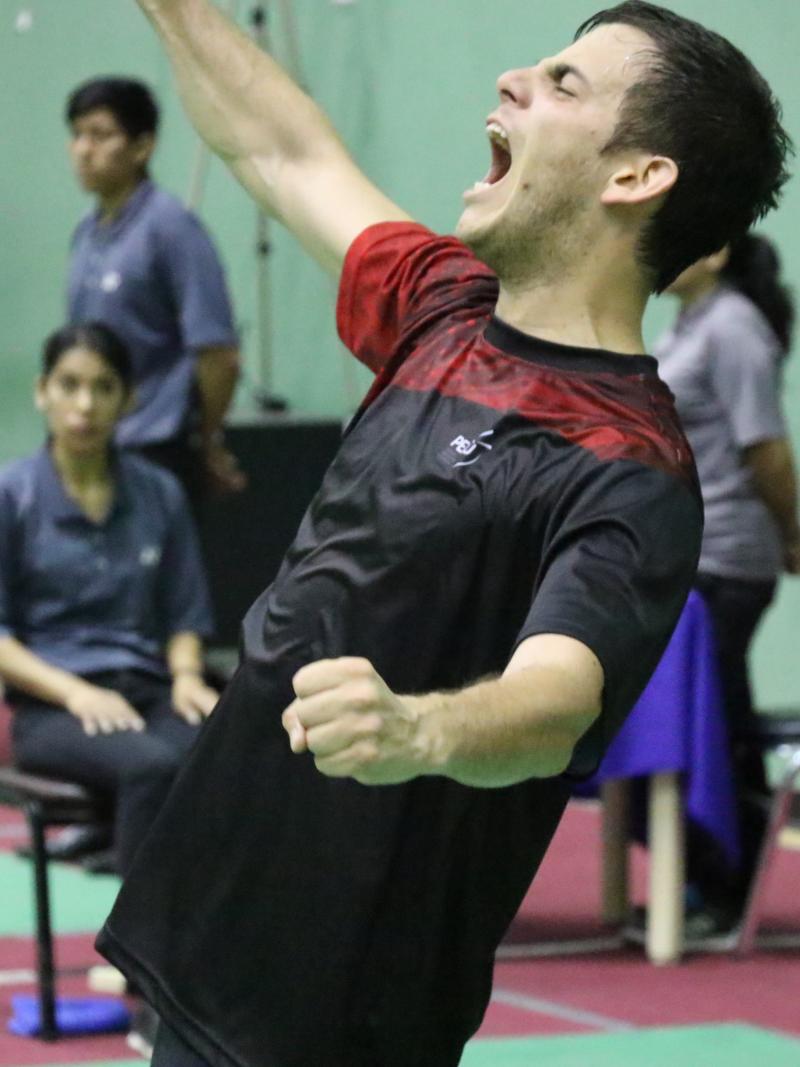 male badminton player Pedro Pablo de Vinatea screams and throws his arms up in celebration