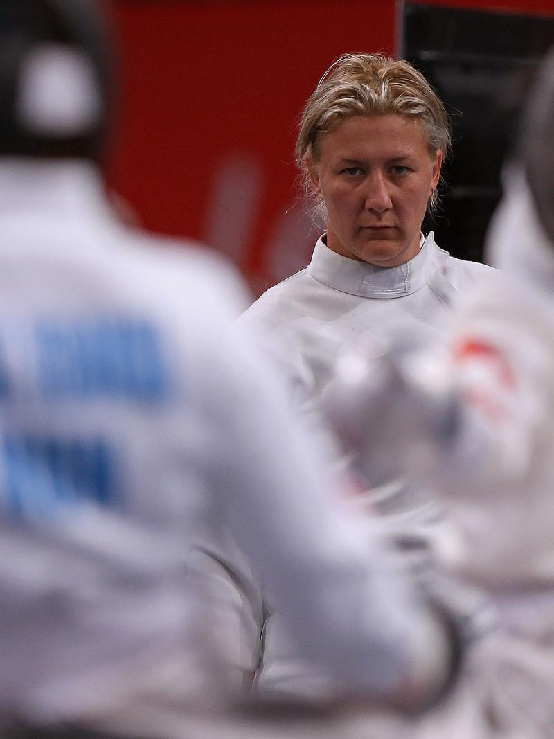 female wheelchair fencer Zsuzsanna Krajnyak with her guard off on the piste