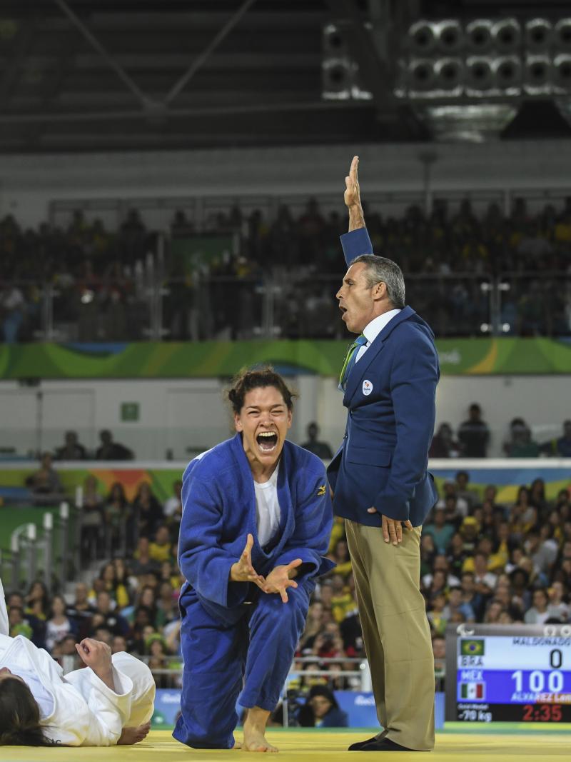 female judoka Lenia Ruvalcaba getting up off her knees and screaming in joy