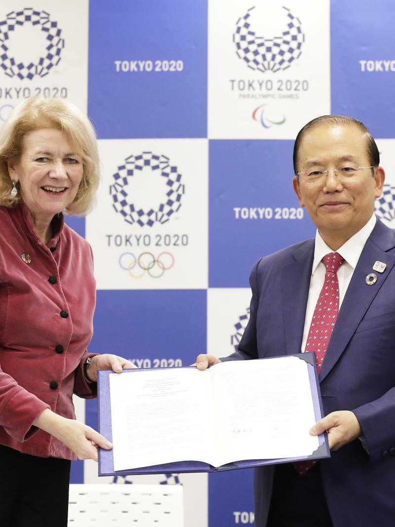 Tokyo 2020's Toshiro Muto and UN official holding a document together