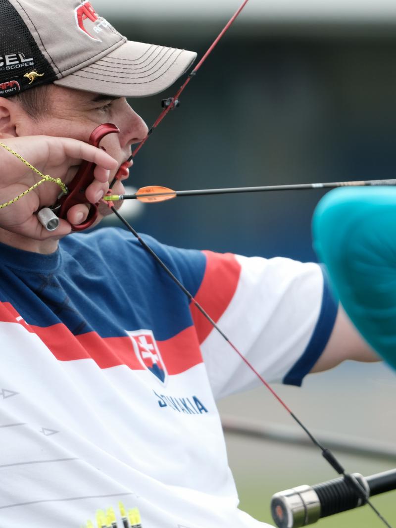 male Para archer Marcel Pavlik pulls back an arrow ready to shoot