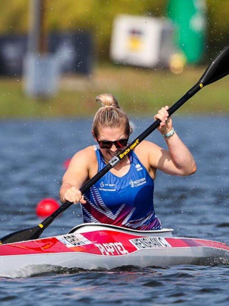 female Para canoeist Charlotte Henshaw makes a stroke through the water