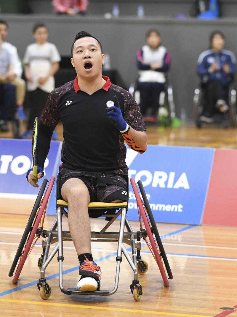 male Para badminton player Chan Ho Yuen punches the air after a winning shot