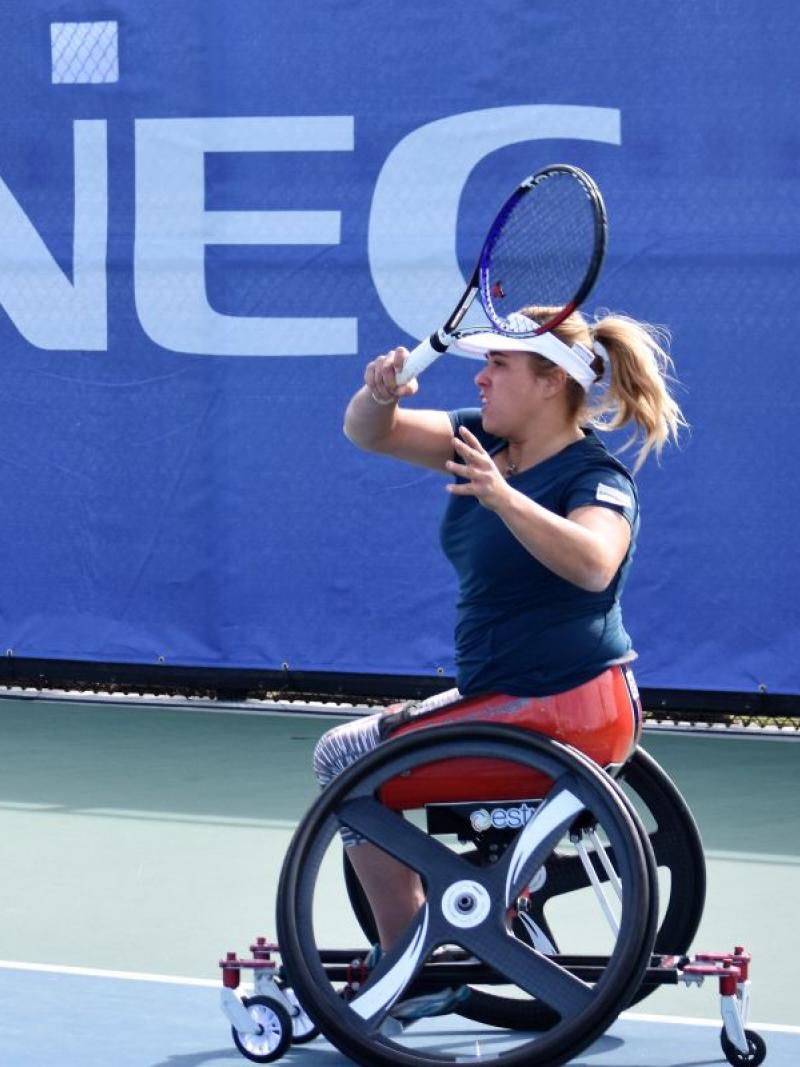 female wheelchair tennis player Giulia Capocci plays a forehand on a hard court