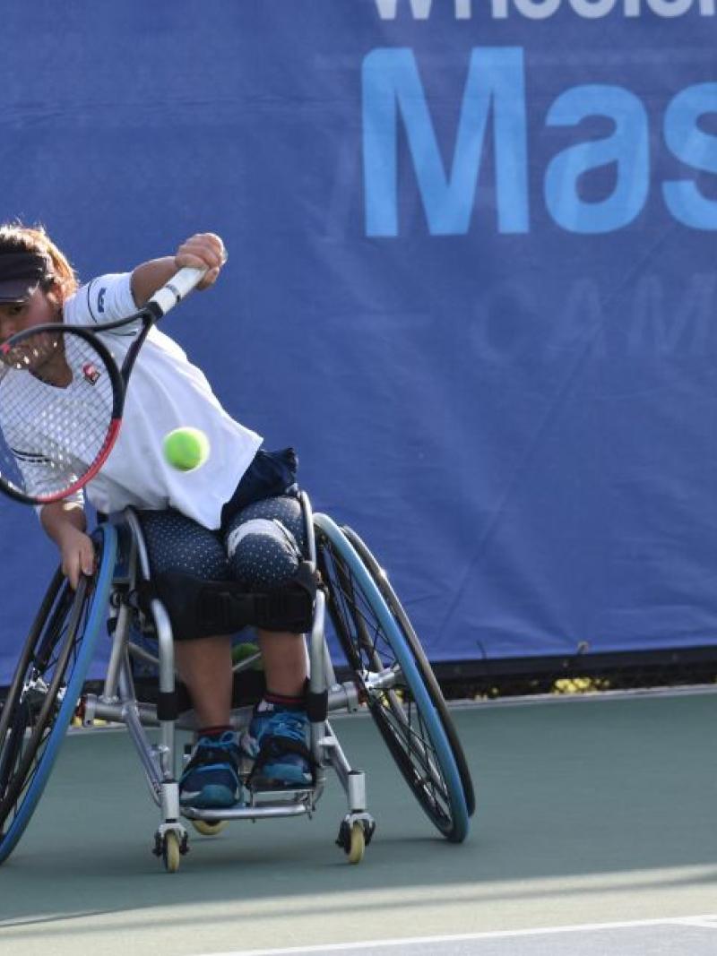 female wheelchair tennis player Yui Kamiji hits a backhand on a hard court