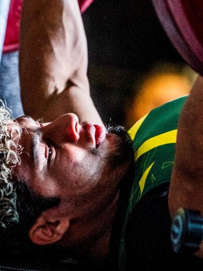 male powerlifter Joao Franca Junior prepares to lift the bar