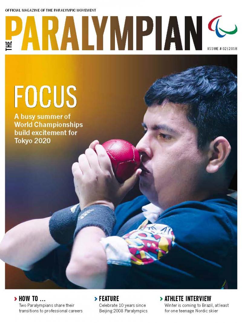 Magazine cover photo of Colombian athlete drawing a boccia ball to his face