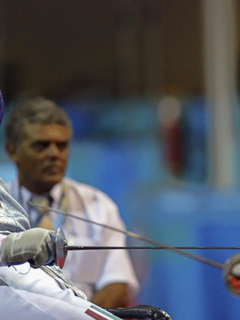 female wheelchair fencer Zsuzsanna Krajnyak dodges away from the foil