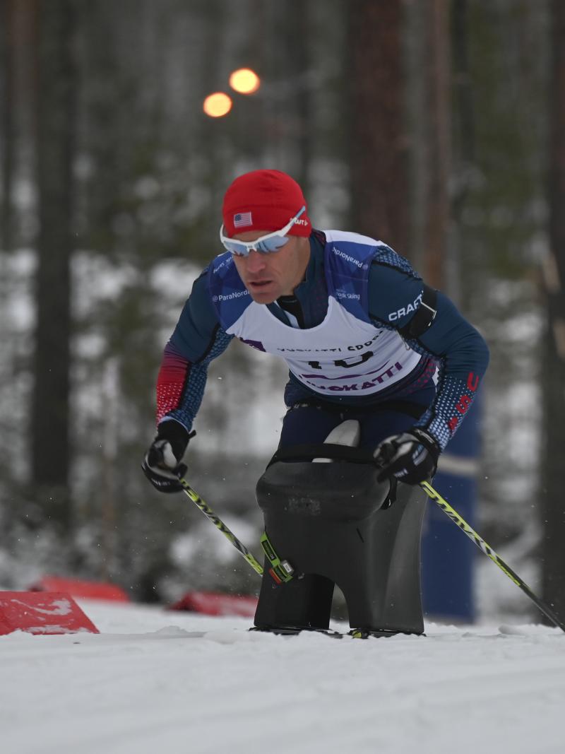 male Para Nordic sit skier Daniel Cnossen pushes through the snow
