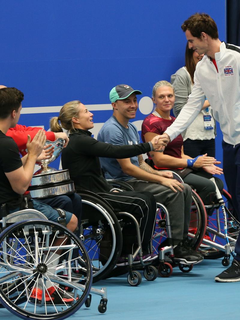 Able bodied tennis player Andy Murray shakes hands with a number of wheelchair tennis players
