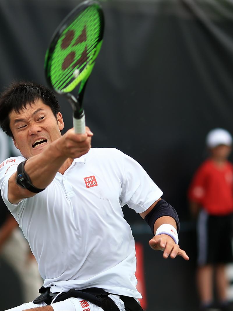 male wheelchair tennis player Shingo Kunieda hits a backhand