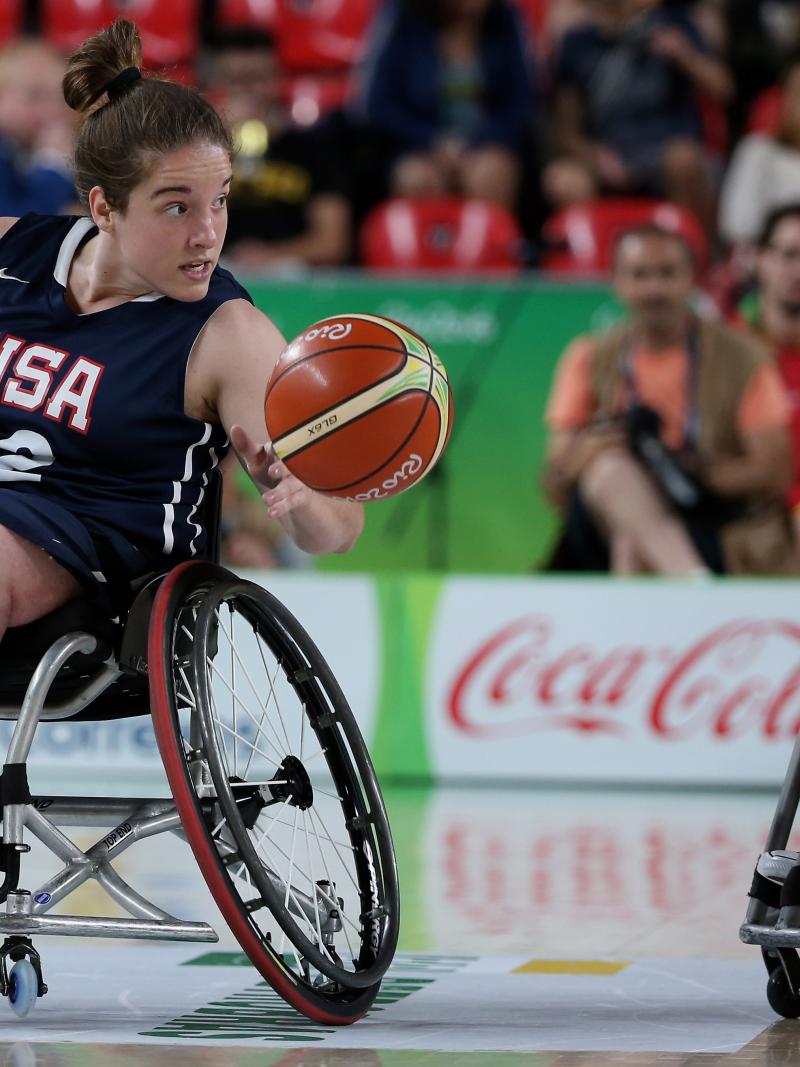 female wheelchair basketballer Rebecca Murray dribbles the ball on court