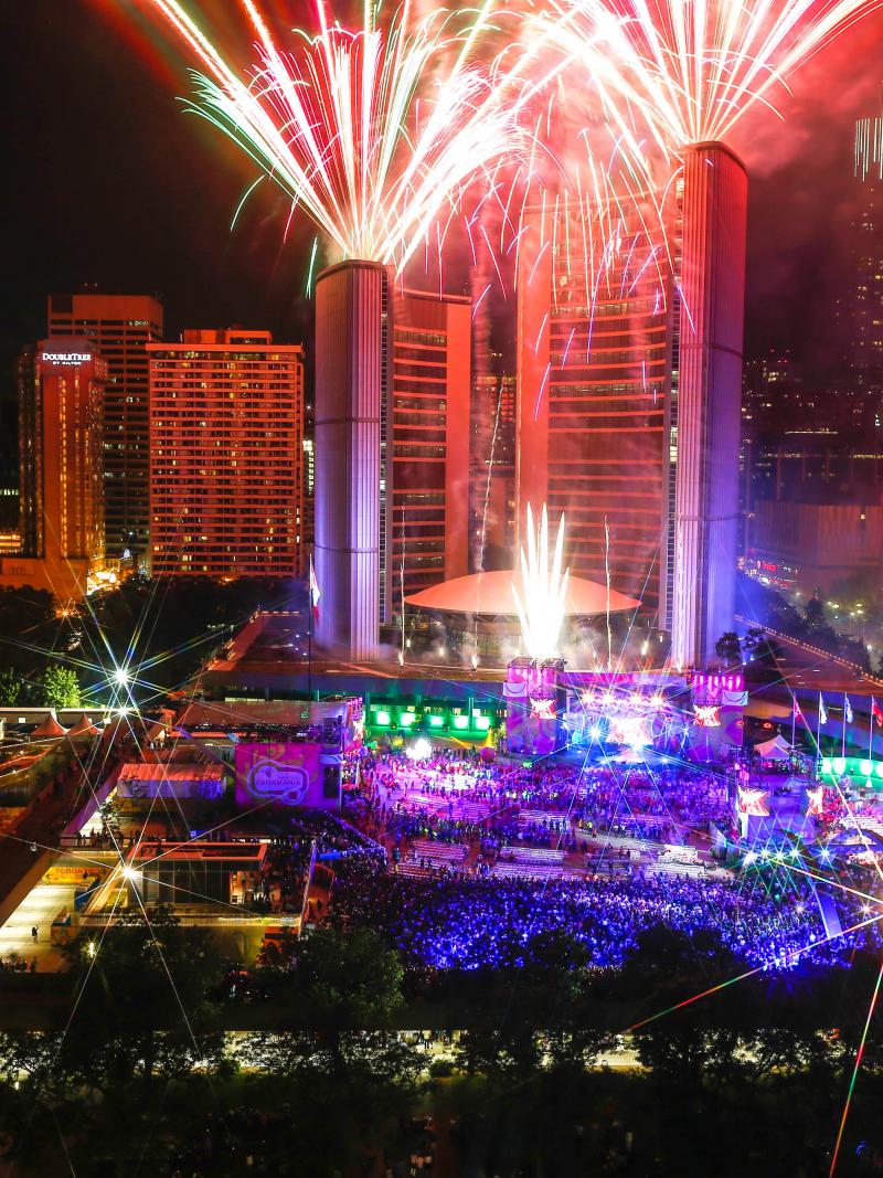 a high shot of fireworks and lasers in central Toronto