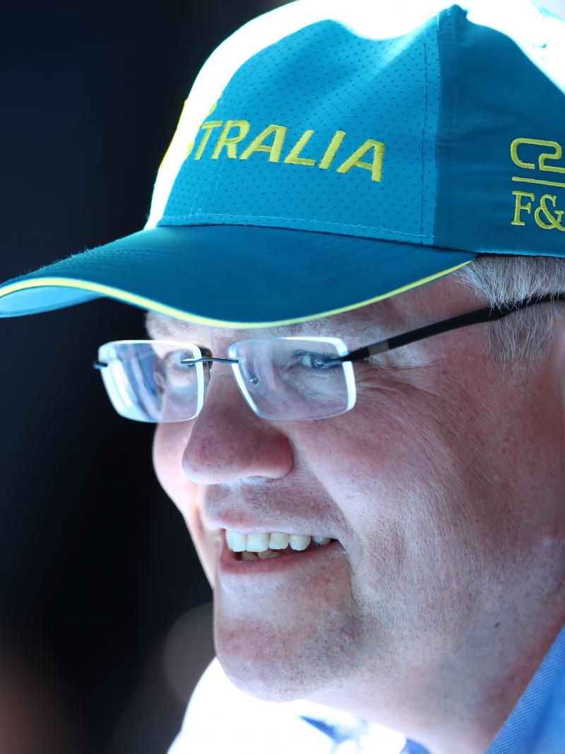 Scott Morrison wearing an Australia baseball cap and smiling