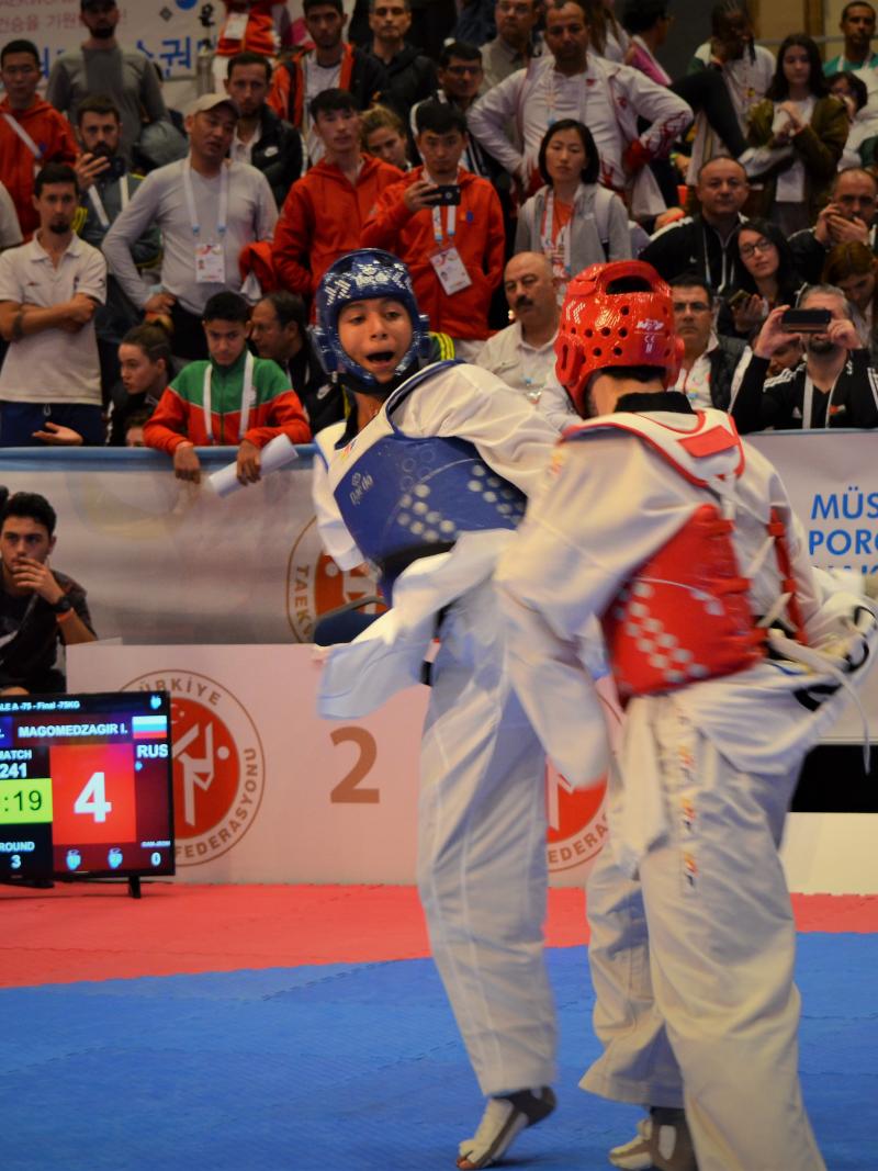 male Para taekwondo fighter Juan Garcia Lopez kicks another fighter around the back