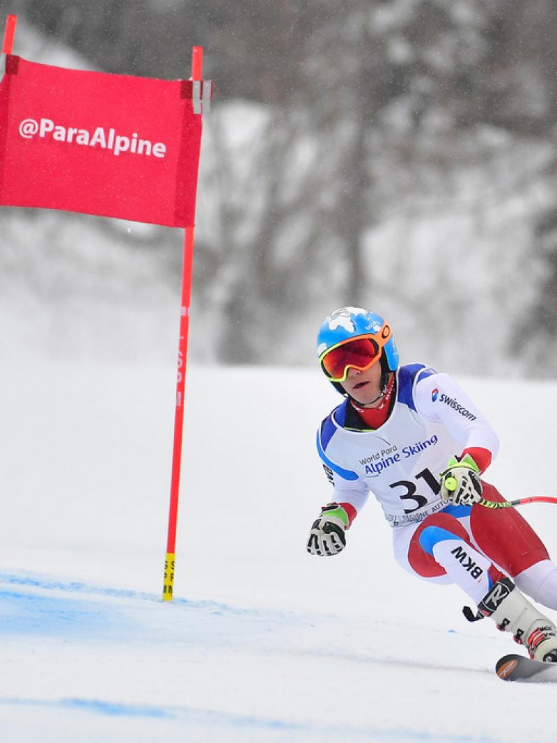 male Para alpine standing skier Theo Gmur skis round a gate