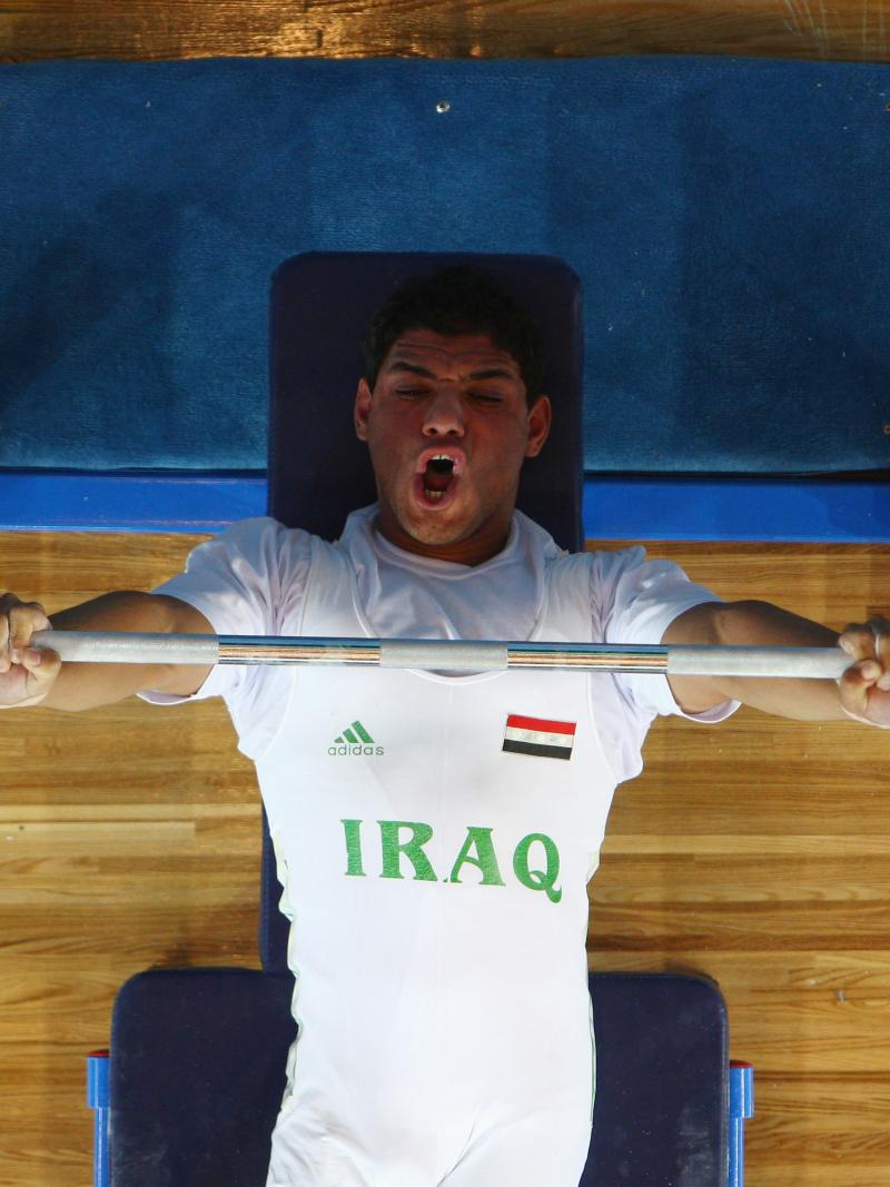 male powerlifter Rasool Mohsin yells as he lifts the bar