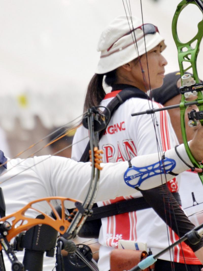 male Para archer Ouk-Soo Lee draws back his bow and prepares to shoot