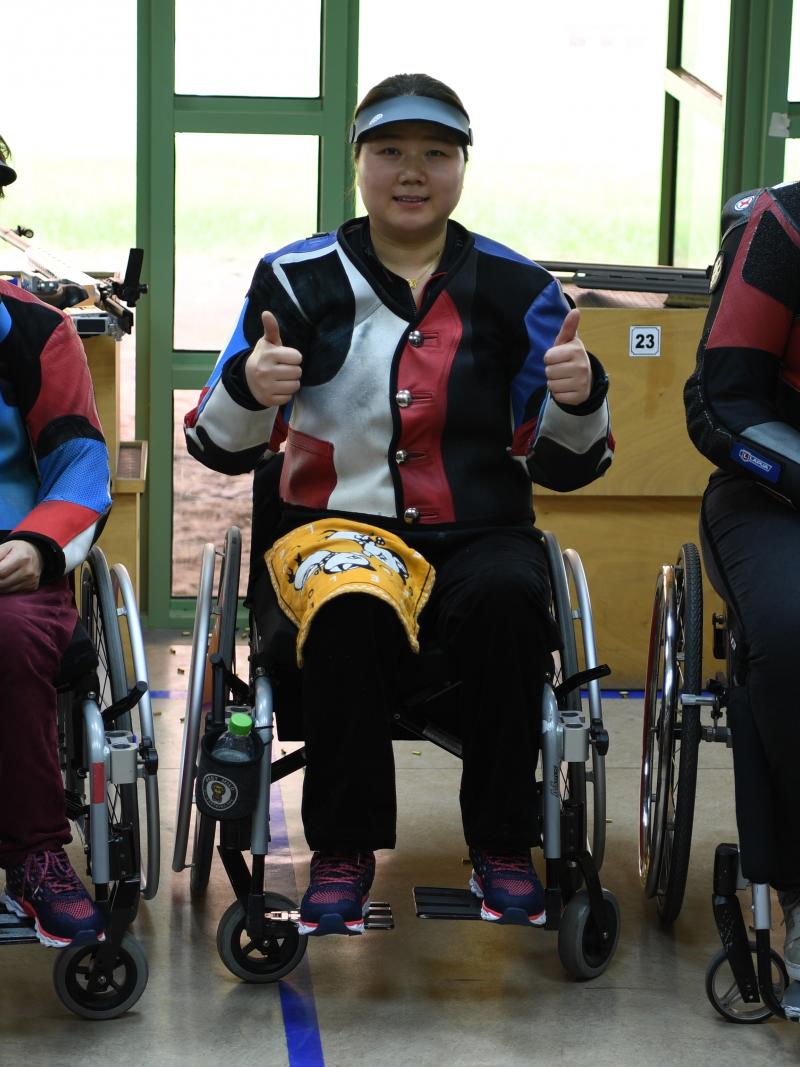 three female Para shooters with Zhang Cuiping giving a thumbs up