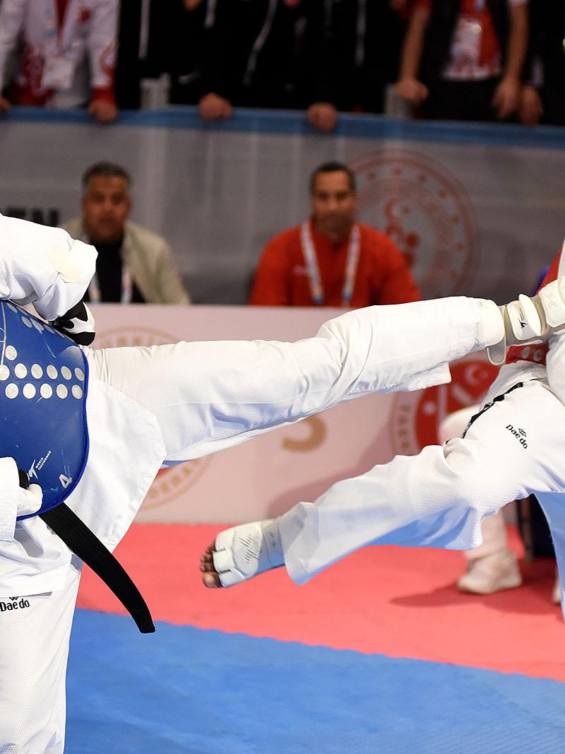 male Para taekwondo fighter Rachid Ismaili Alaoui kicks another fighter in the chest
