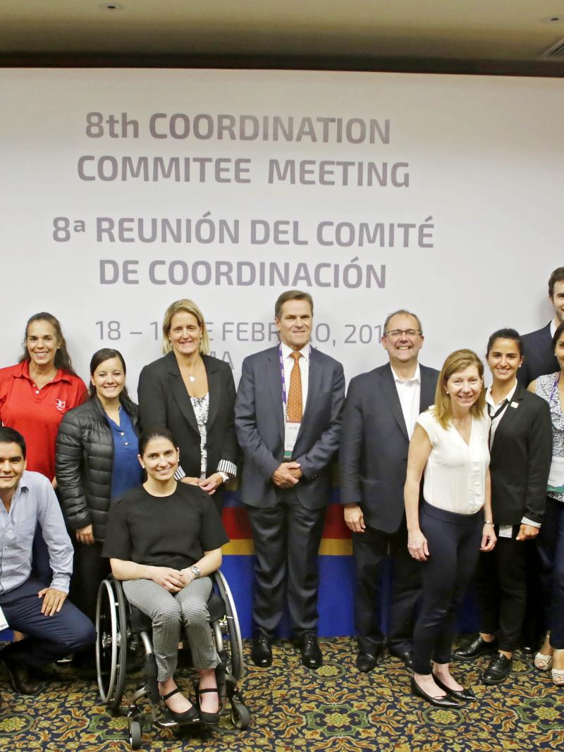 a group of people in suits smiling