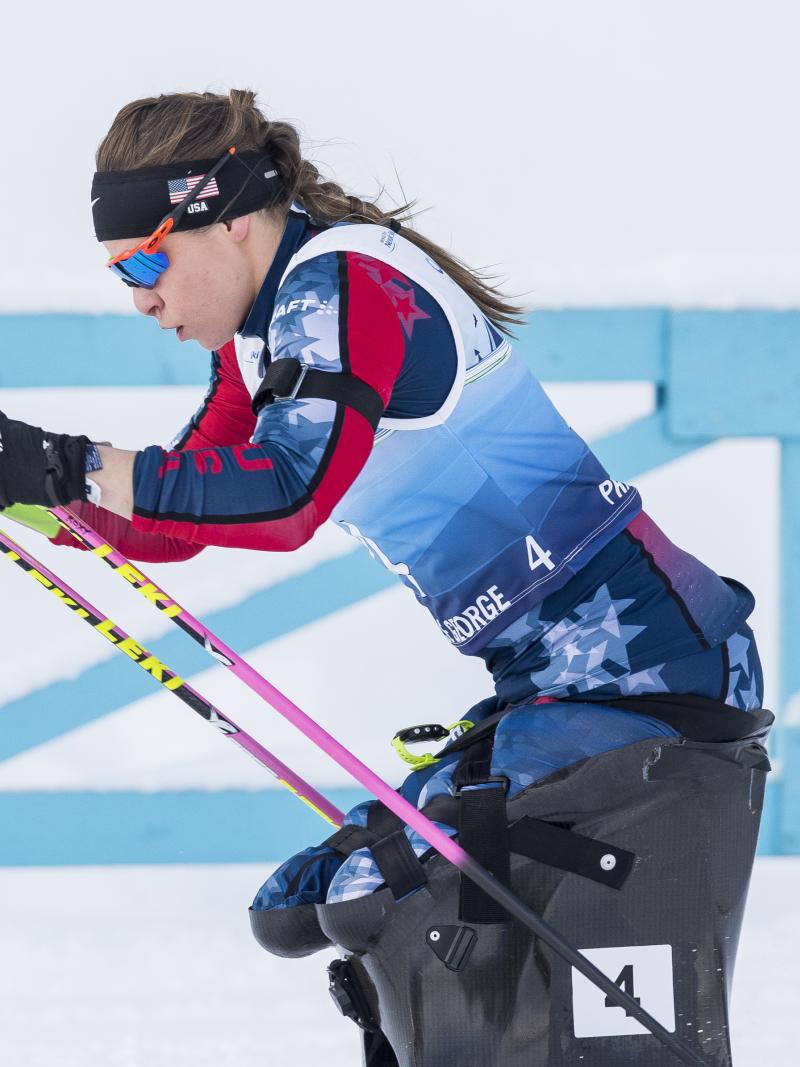 female Para Nordic skier Oksana Masters drives her ski poles through the snow