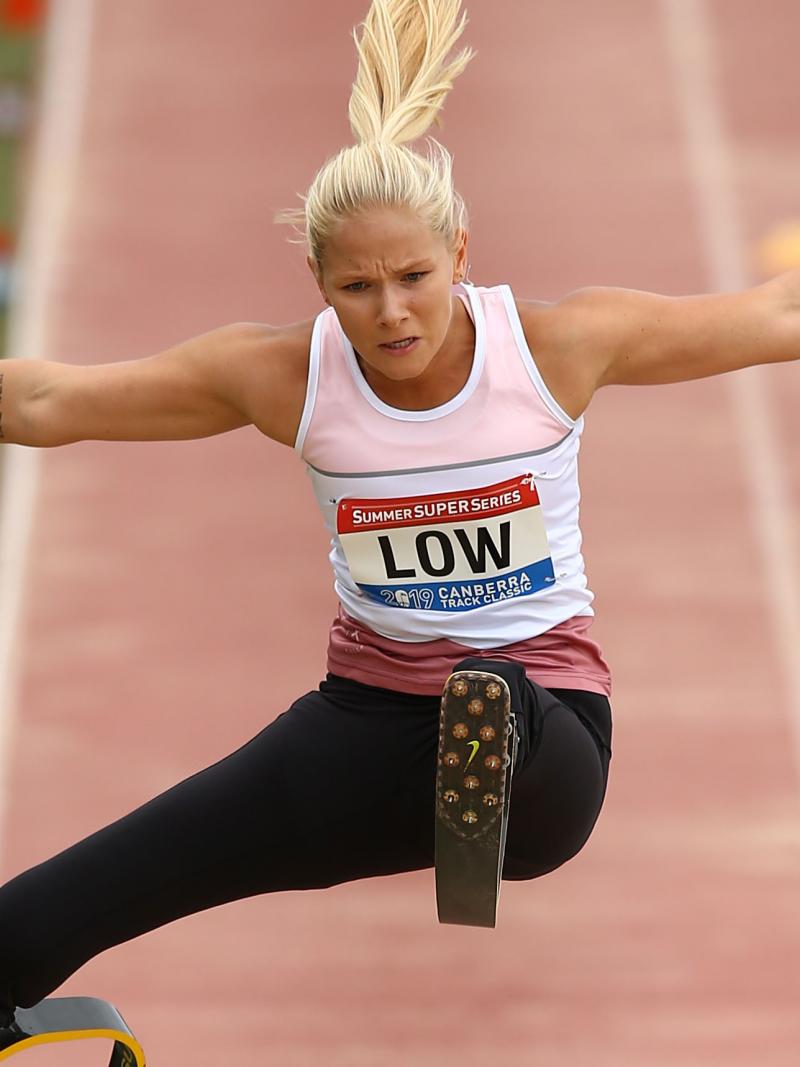 female Para athlete Vanessa Low jumps high above the long jump sandpit