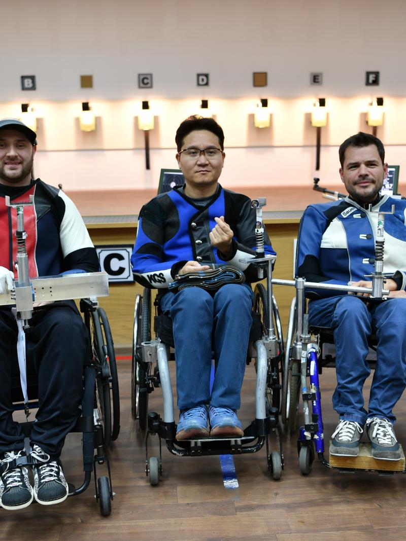 Three male shooters in wheelchairs