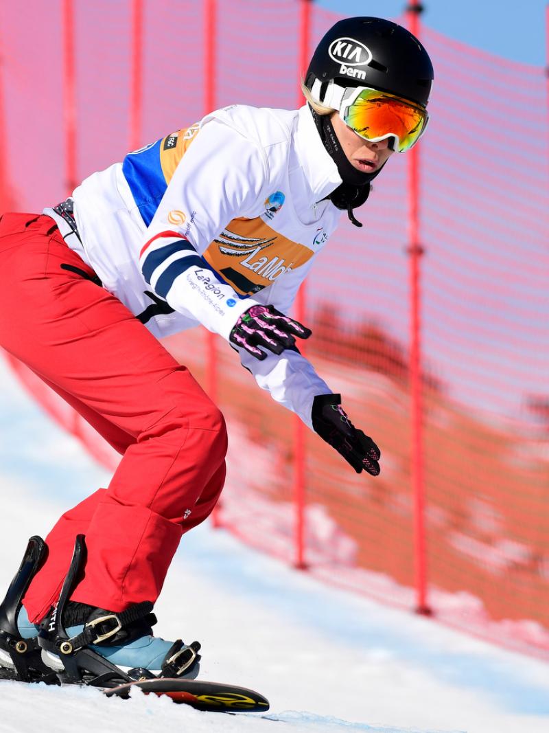 A female Para snowboarder competing