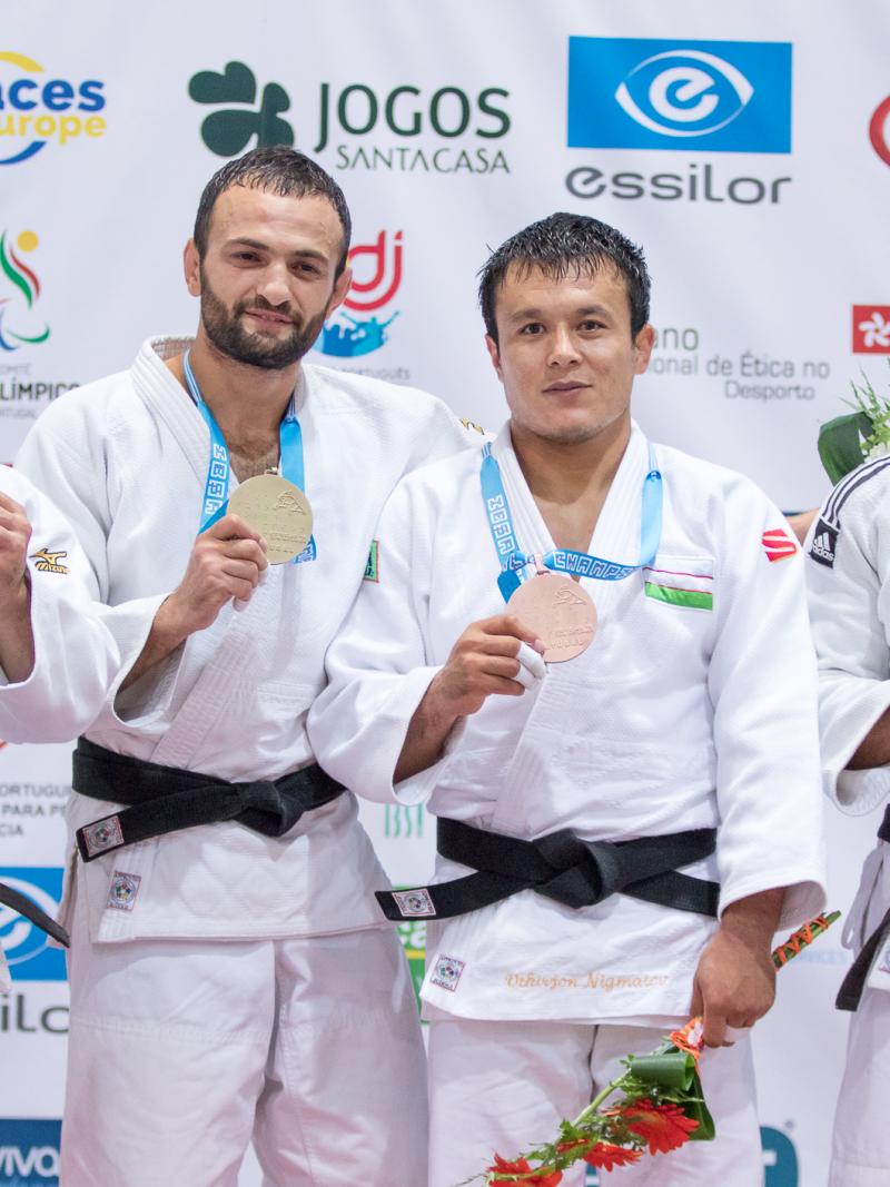 four male judokas on the podium with their medals, with Giorgi Gamjashvili on the end holding bronze