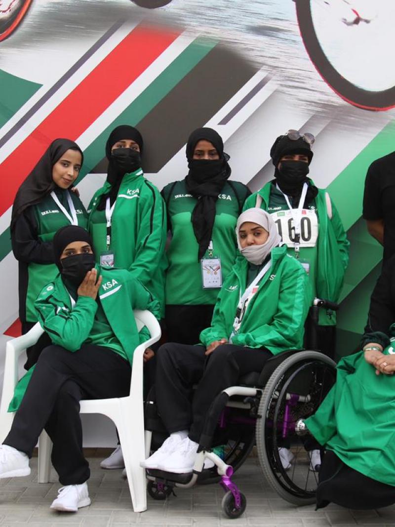 a group of female Saudi Arabian Para athletes and their two male coaches