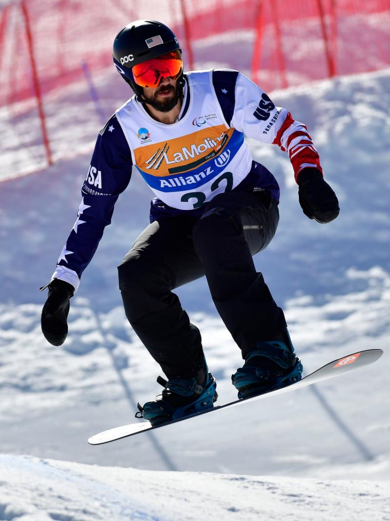 A male Para snowboarder competing