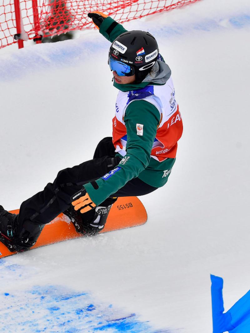 male Para snowboarder Chris Vos goes round a banked slalom bend