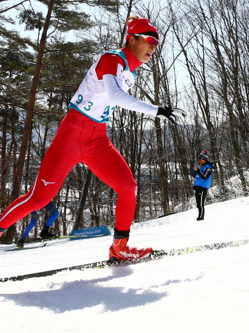 male Para Nordic skier Taiki Kawayoke skis through the forest
