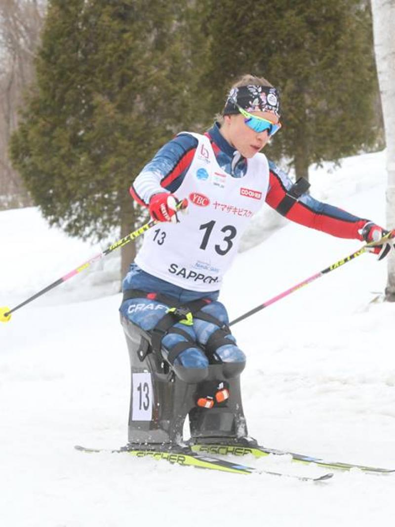 female Para Nordic sit skier Oksana Masters turns round a bend in the course