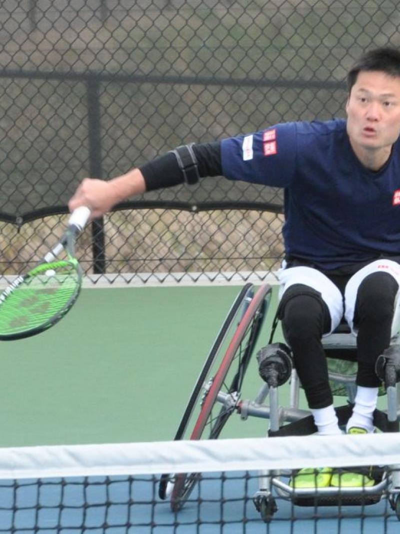 male wheelchair tennis player Shingo Kunieda prepares to play a backhand on a hard court