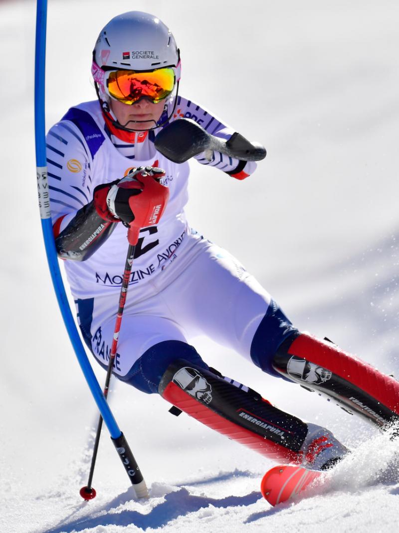 female Para alpine skier Marie Bochet turns through a gate