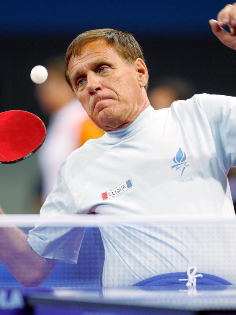 male Para table tennis player Matti Launonen plays a forehand